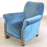 An early 20th century carved oak and blue upholstered armchair