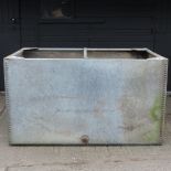 A galvanised metal water trough,