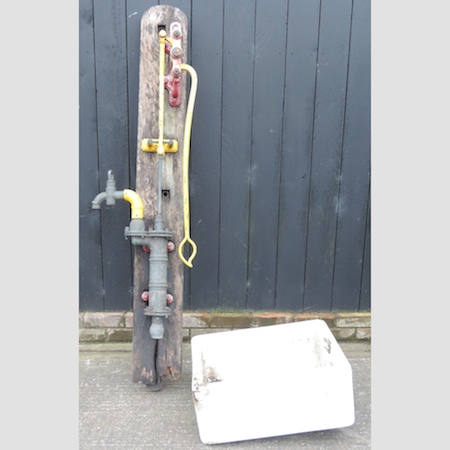 A white glazed butler's sink, 61cm, together with an antique water pump, on wooden mounts,