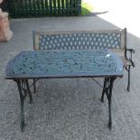 A green painted metal garden table, together with a bench,