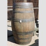 A large coopered wooden barrel,