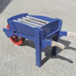 A blue painted wooden wheelbarrow,