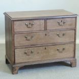 A George III style oak chest of drawers,