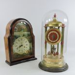 An early 20th century anniversary clock, contained under a glass dome, 42cm tall,