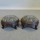A pair of Victorian carved walnut circular footstools,