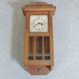 A 1930's oak cased wall clock,