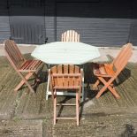 A set of four teak folding garden chairs