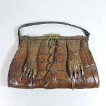 An early 20th century crocodile skin handbag