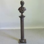 A bronzed bust of a lady, on a pedestal base,