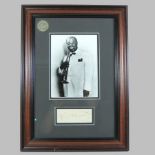 A framed photograph of Louis Armstrong, 1901-1971, American Jazz Musician,