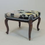A Victorian tapestry upholstered footstool, on cabriole legs,