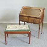 A tapestry upholstered footstool, together with a 1920's French walnut bureau,