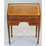 An early 20th century mahogany, satinwood and harewood marquetry bureau, with a hinged sloping fall,