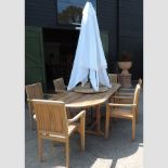 A teak oval extending garden table, 235cm, together with six chairs,
