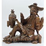An early 20th century Chinese carved hardwood figure of seated man,