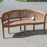 A teak curved garden bench,