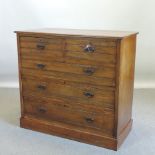 An Edwardian ash chest of drawers, on a plinth base,