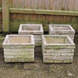 A set of four square stone planters,