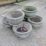A collection of six circular reconstituted stone garden pots,