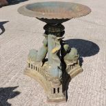 A 19th century cast iron garden fountain, on three dolphin supports,