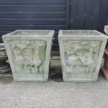 A pair of reconstituted stone garden planters, with relief decoration,