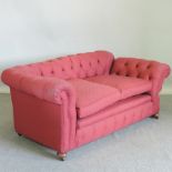 A red upholstered two seater Chesterfield sofa,