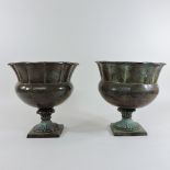 A pair of metal and verdigris urns, 28cm tall,
