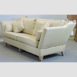 A gold upholstered three seater sofa, by Multiyork,