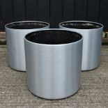 A set of three silver coloured garden pots,