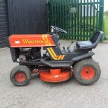 A red Westwood ride on petrol lawnmower