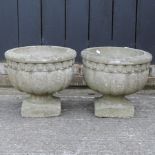A pair of reconstituted stone circular garden planters,