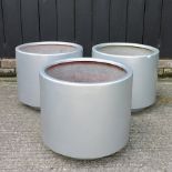 A set of three silver coloured garden pots,