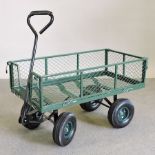 A green painted metal garden cart,