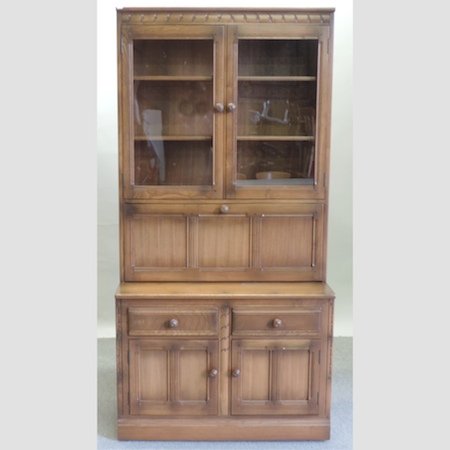 An Ercol medium elm cabinet bookcase,