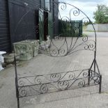 A black painted wrought iron garden planter with screen,