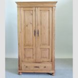 A pine double wardrobe with a single drawer,