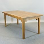 A modern pine kitchen table, on tapered legs,