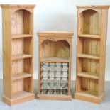 A pair of pine open bookcases, together with a modern pine wine rack,