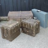 An ammunition box, together with another, a military case and a cabin trunk,