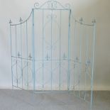 A blue painted metal three-fold garden screen,