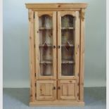 A pine and stained glass corner cabinet,