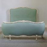 A French cream painted and blue upholstered double bedstead,