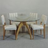 A contemporary Conran Boomerang dining table, with a glass top, 120cm diameter,