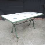 A green painted iron and travertine tiled bespoke made garden table,