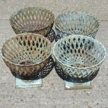 A set of four cast iron lattice planters,