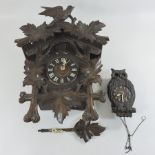 A Victorian carved cuckoo clock, 46cm tall, together with a carved clock in the form of an owl,