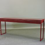 A modern red two drawer console table,