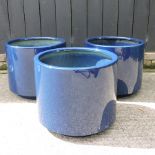 A set of three blue garden pots,