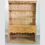A modern pine dresser, containing two drawers, with pot board below,
