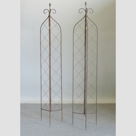 A pair of metal lattice garden spires,